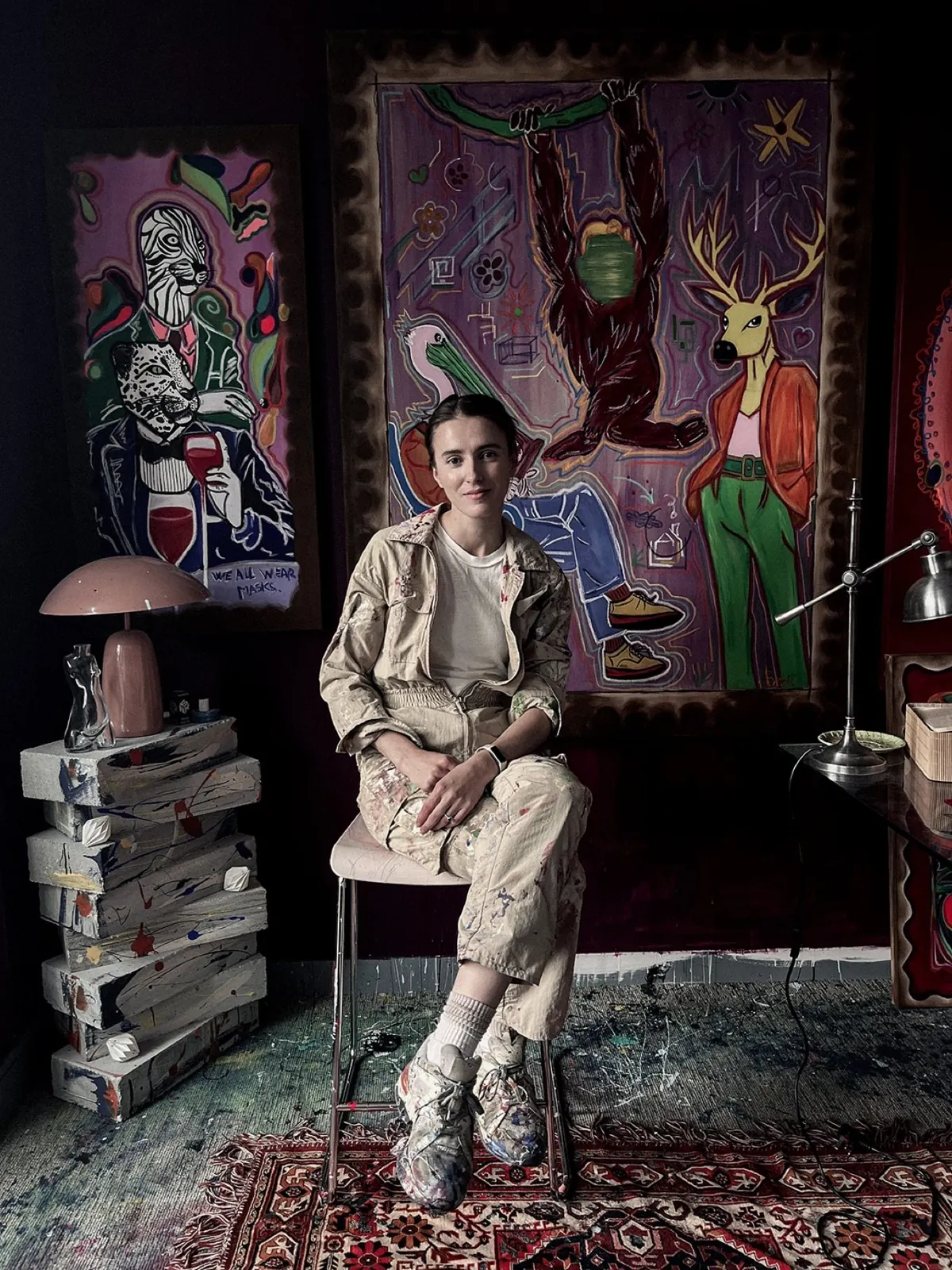 Artist Camelia in her studio with her paintings